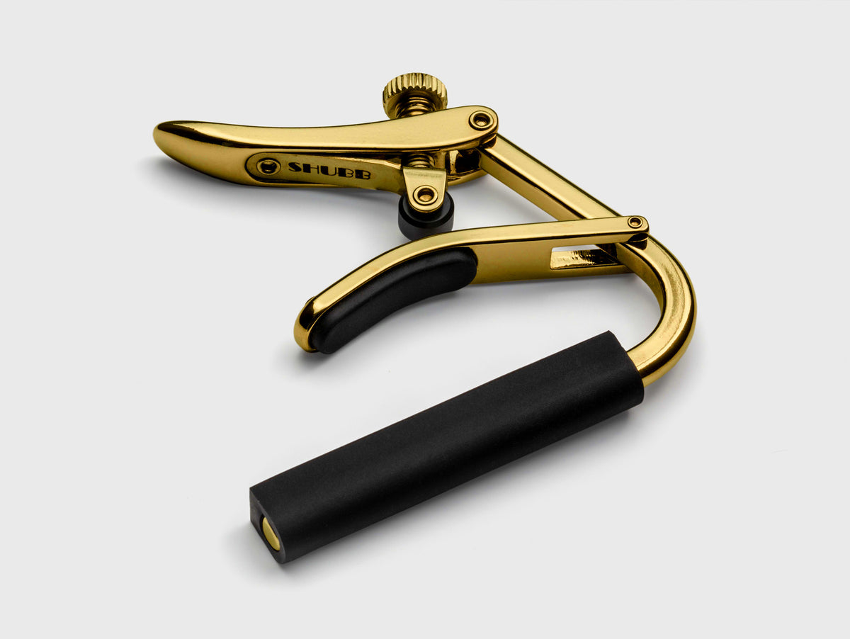 Capo Royale C2G pour guitares cordes nylon (touche plate), finition titane haute-qualité, doré
